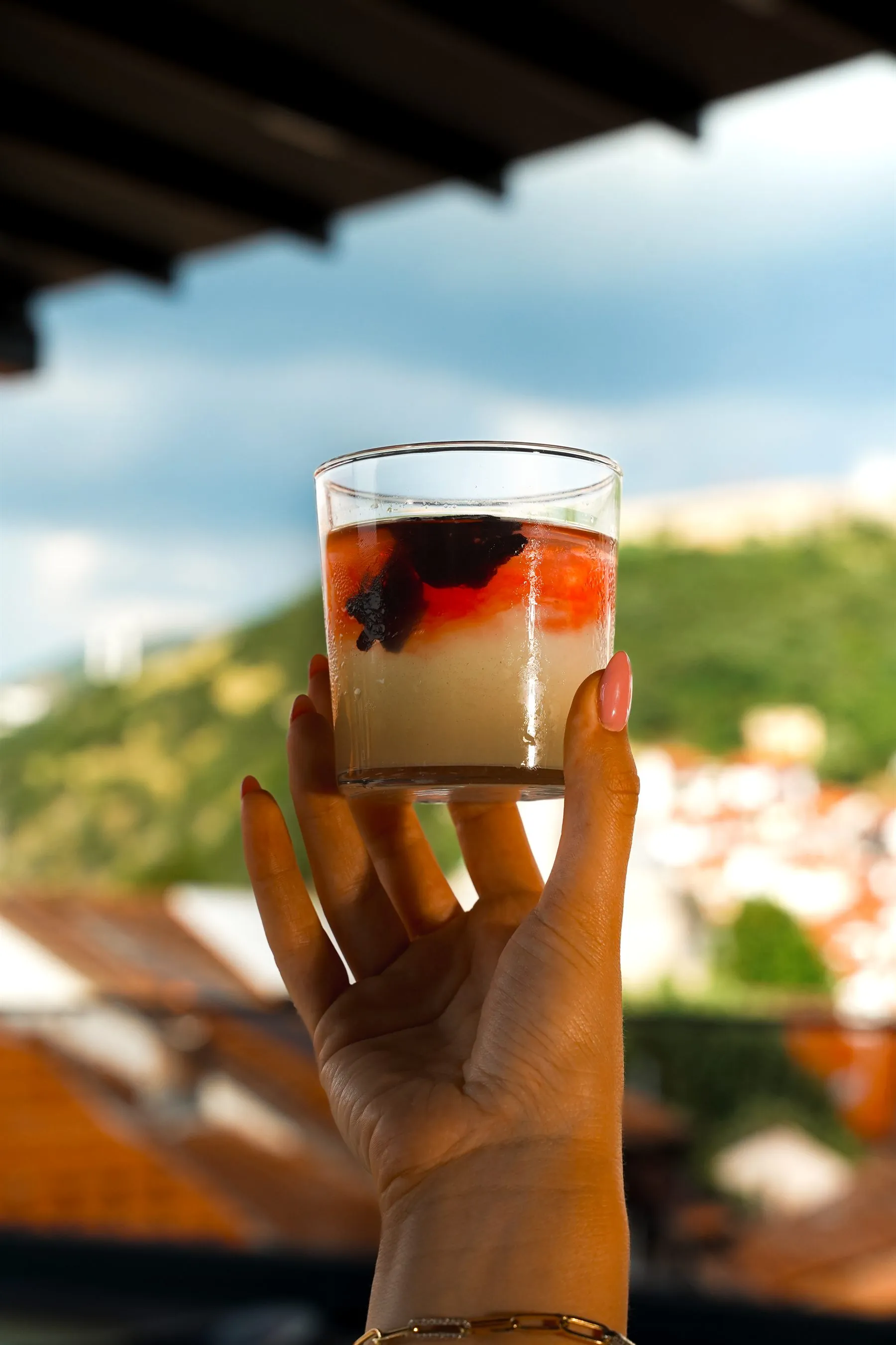 A cocktail raised above the old town of Prizren, the fortress hill behind